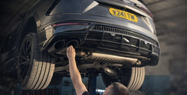 Mechanic inspecting SUV undercarriage